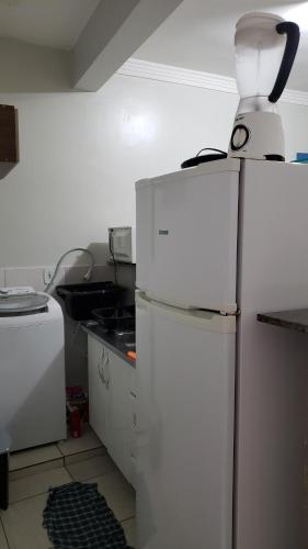 a white refrigerator with a jug on top of it at Apto aconchegante no Guará II,próximo ao aeroporto in Brasilia