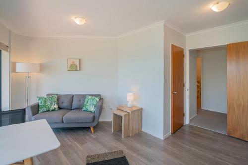 a living room with a couch and a table at Oceana Heights Paradise - Beautiful 2 bdrm self contained apartment in Tairua