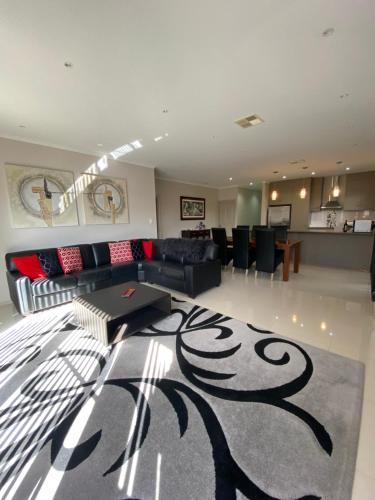 a living room with a black and white rug at Casavino Luxury Villa in McLaren Vale