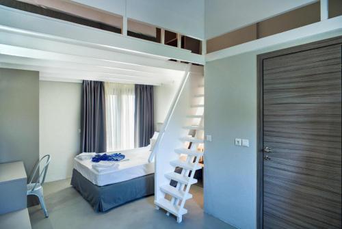 a bedroom with a bunk bed and a ladder next to a bed at Apartments Sani Woods, Sani in Elani