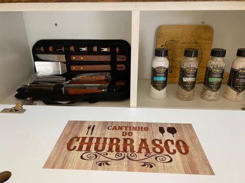 a drawer with a bottle of champagne and a sign at Minicasa Brasileira in Sorocaba