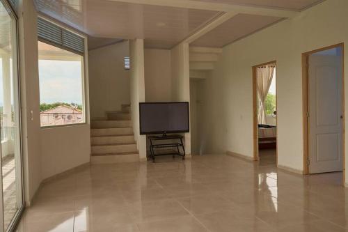 a living room with a flat screen tv in it at Casa vacacional Girardot 5 habit in Girardot
