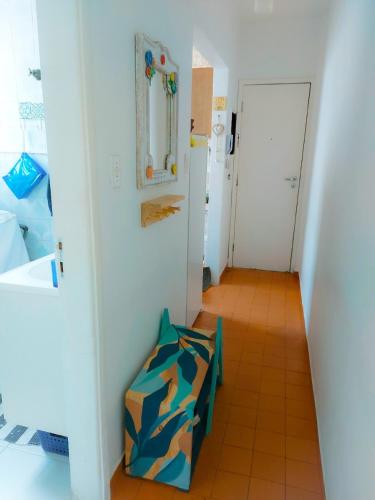 a room with a hallway with a chair and a door at Vista&Aconchego in Santos