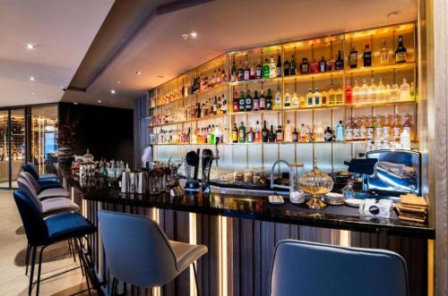 a bar with a bunch of bottles on the wall at Best Western Plus Congress Hotel Yerevan in Yerevan