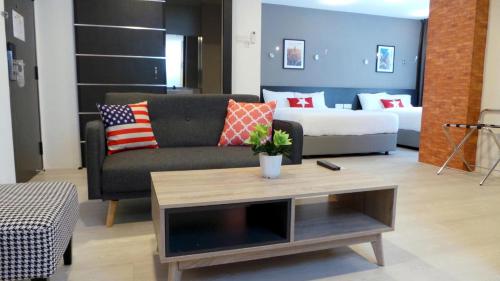 a living room with a couch and a coffee table at Manhattan Hotel Ipoh in Ipoh