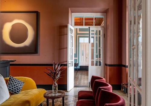 a living room with a couch and chairs at Roça Sundy - Principe Collection in Santo António