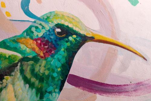 a painting of a peacock with a colorful head at Kame House hostel in Huaraz
