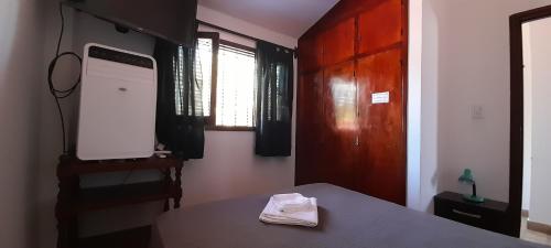 um quarto com uma mesa e uma televisão na parede em Apartamento Virgen del Cerro Salta em Salta