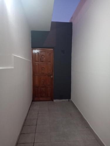 a hallway with a wooden door in a room at Casa Termas in Termas de Río Hondo