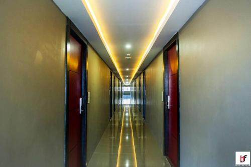 a hallway of a building with a long corridor at The Harbour Front Hotel in Suratthani