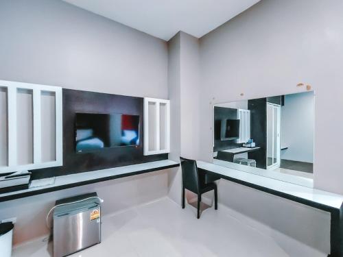 a bathroom with a desk and a mirror at The Harbour Front Hotel in Suratthani