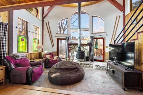 a living room with a couch and a tv at The Valley's Cabin in Green Valley Lake