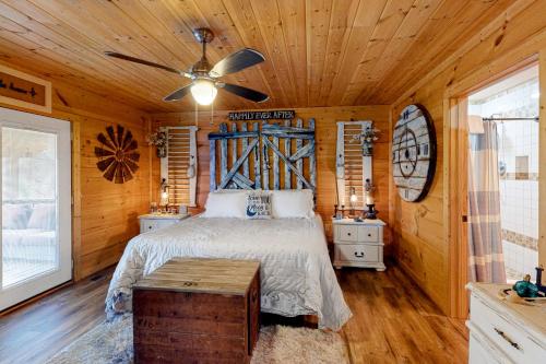 a bedroom with a bed and a ceiling fan at Lucky Clover Cabin in Blairsville