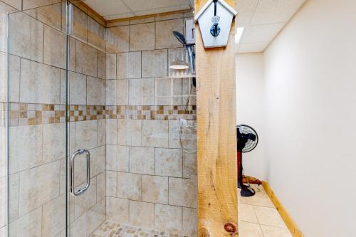 a bathroom with a shower with a clock on the wall at Lucky Clover Cabin in Blairsville