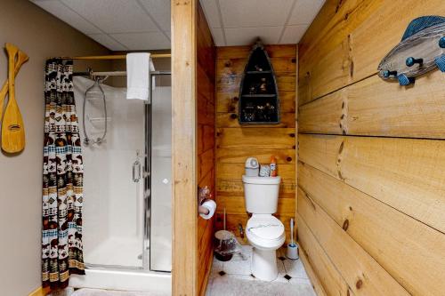 a wooden bathroom with a toilet and a shower at Lucky Clover Cabin in Blairsville