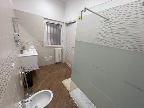 a white bathroom with a sink and a shower at B&B Miramare Suite Borgo in Taranto