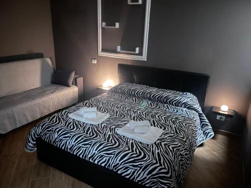 a bed in a room with a zebra blanket at B&B Miramare Suite Borgo in Taranto