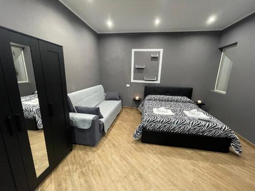 a small room with a bed and a couch at B&B Miramare Suite Borgo in Taranto