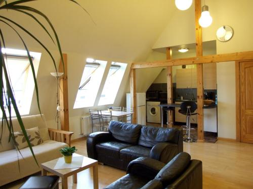a living room with a couch and a table at Sunlit Loft Apartment Riga in Rīga