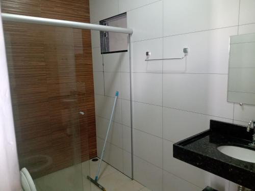 a bathroom with a shower and a sink at Casa Família Porto in Olímpia