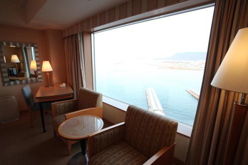 a room with a large window with a view of the water at JR Hotel Clement Takamatsu in Takamatsu