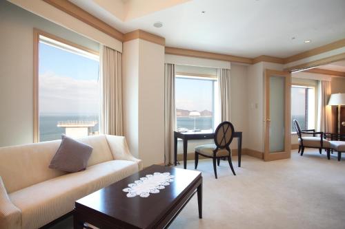 a living room with a couch and a table at JR Hotel Clement Takamatsu in Takamatsu