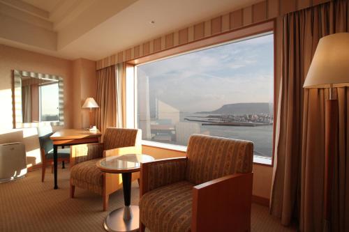 a hotel room with a large window with a view at JR Hotel Clement Takamatsu in Takamatsu
