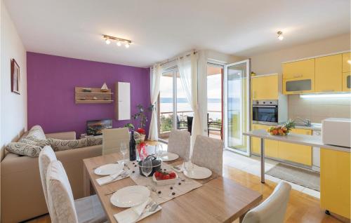 a kitchen and a dining room with a table and chairs at Apartment Podstrana With Sea View 366 in Podstrana