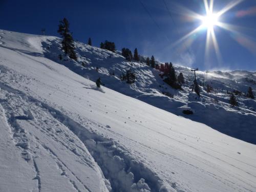a person is skiing down a snow covered slope at Ferienwohnung Zillertal - Schwemberger in Fügen