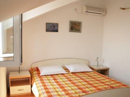 a bedroom with a bed with two pillows on it at Apartment Miranda in Bol