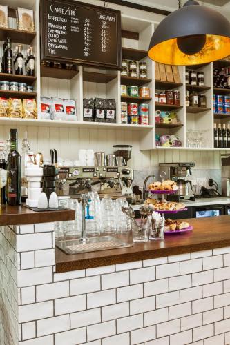 a kitchen with a counter with a sink in a restaurant at Elite Hotel Ideon, Lund in Lund