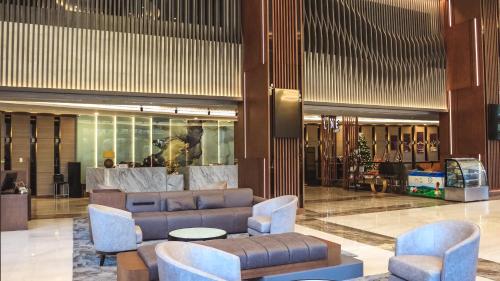 a lobby with couches and chairs in a building at Malibu Hotel in Vung Tau