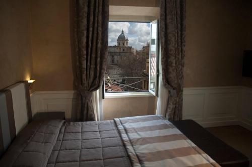 a bedroom with a window with a view of a building at Relais La Maison De Luxe in Rome