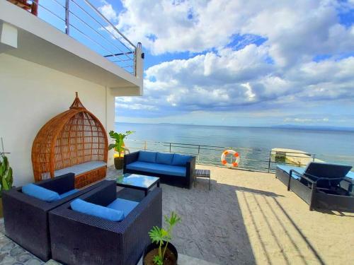 a patio with couches and a view of the ocean at The Philip Ann Resort in Mabini