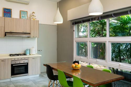 a kitchen with a table with a bowl of fruit on it at The Friendship Villa by Amatak in Siem Reap