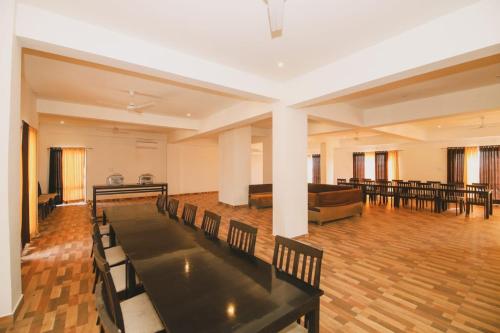 a large room with tables and chairs and a couch at Hotel Dosa plaza in Udaipur
