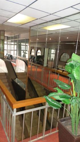 a room with a train with chairs and a plant at Coastlands Durban Self Catering Holiday Apartments in Durban