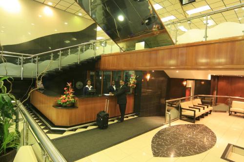a man standing in the lobby of a building at Coastlands Durban Self Catering Holiday Apartments in Durban