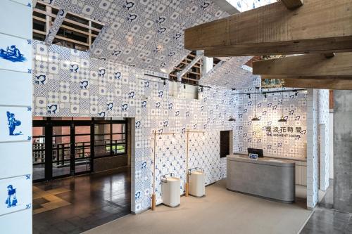 a room with a wall covered in blue and white tiles at The Moment Hotel Yilan by Lakeshore in Wujie