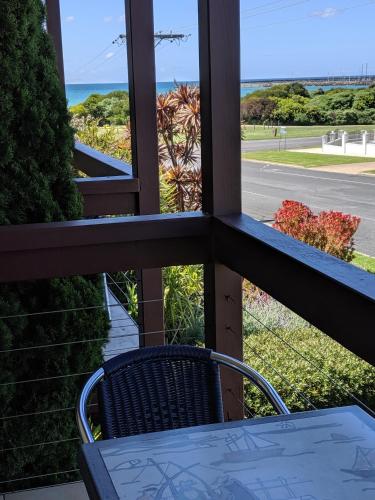 a balcony with a table and a view of the ocean at Seaview Motel & Apartments in Apollo Bay