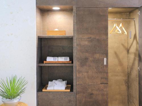 a wooden closet with some boxes on it at 鸛巣（ムカカヴィラ コウノス) in Nakijin