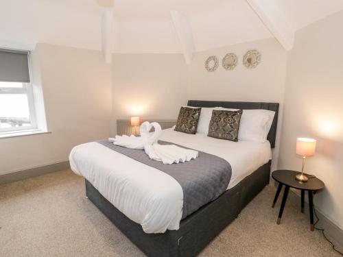 a bedroom with a bed with a swan on it at Rose Suite in Barmouth