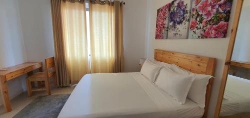 Ένα ή περισσότερα κρεβάτια σε δωμάτιο στο Hasara Oceanfront Apartments