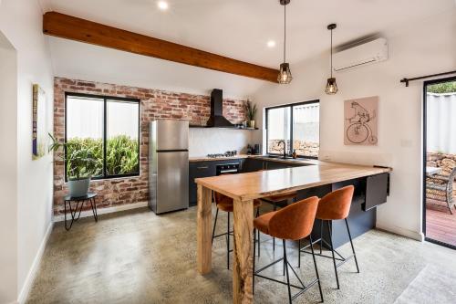 a kitchen with a wooden table and some chairs at Alley Cats in Margaret River Town