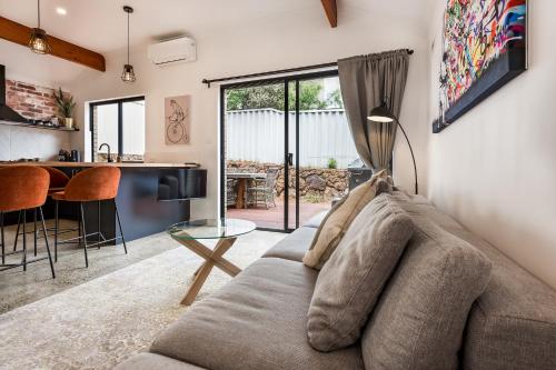 a living room with a couch and a table at Alley Cats in Margaret River Town