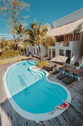 a woman laying on the edge of a swimming pool at a resort at Pajamas Koh Chang in Ko Chang