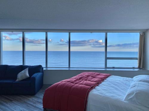 a bedroom with a bed and a view of the ocean at Atlantic Palace in Atlantic City