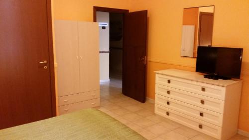 a bedroom with a dresser with a television on it at Hotel Gorizia in Catania