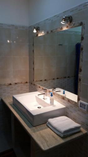 a bathroom with a white sink and a mirror at Hotel Gorizia in Catania