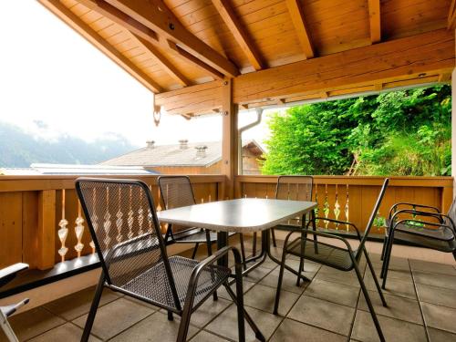 a patio with a table and chairs on a deck at Magnificent Apartment in Mittersil with Sauna in Mittersill